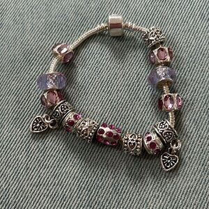 Silver charm bracelet let with pink rhinestone beads